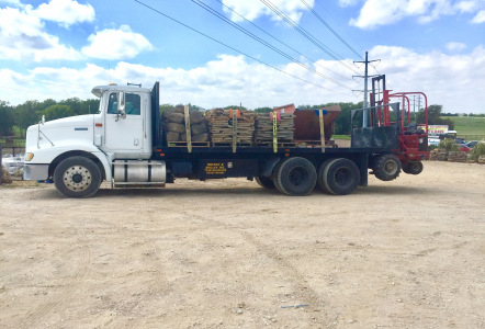 Flatbed delivery truck with forklift