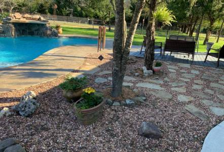 Cinnamon Gravel $220/yard  spread out near a pool area .  Install by Top Notch Landscaping.