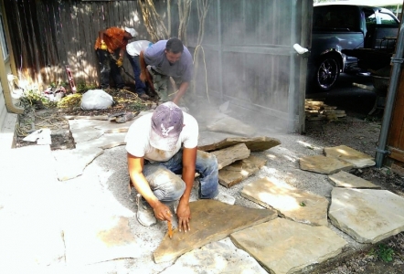 Stone Masons working up a sweat doing a flagstone patio.