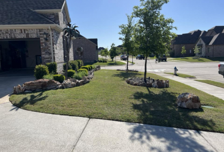 Onyx Boulders used as flowerbed edging and as accents.