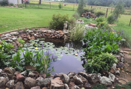 Moss Boulders were used to outline this pond installed by Independent Landscape.