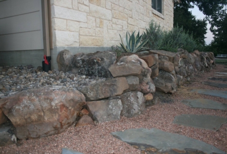 Moss Boulders lining a decomposed granite walkway installed by Texas Outdoor Oasis.