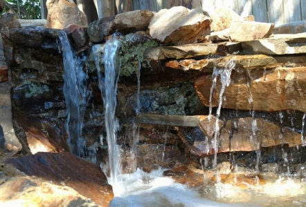 Moss Boulders were used to create this beauty installed by Water Features of Texas.