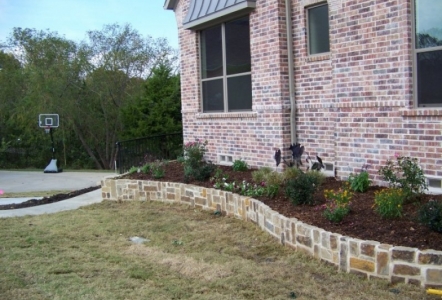 Oklahoma Chopped used in a small wall for raised flowerbeds.