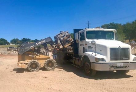 Flatbed delivery truck being loaded.