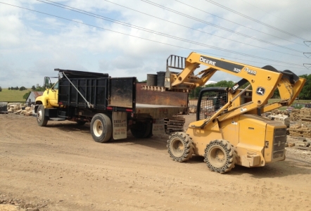 Loading the long bed dump truck.