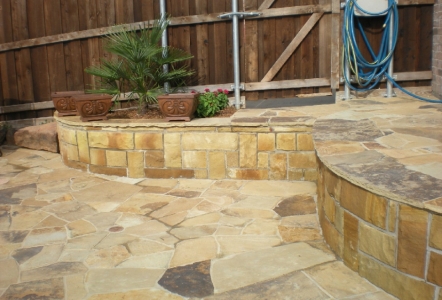 Lovely patio area with raised stone walls.