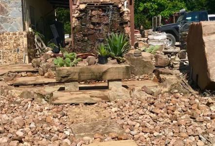 Cherokee River Rock surrounds a stone walkway up to our waterfall area here at Classic Rock.