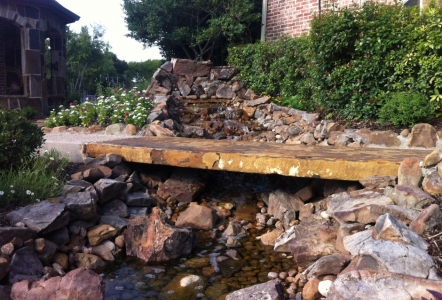 An oversized slab was used as a bridge for this water feautre.