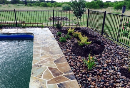 Oklahoma Flagstone around pool with Arizona River Rock