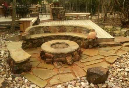 Stone bench seating around a firepit.