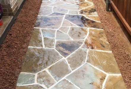 Flagstone walkway with Decomposed Granite along edges.