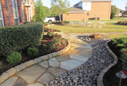 Walkway done with Oklahoma Flagstone, Arizona River Rock, and Oklahoma Ledge as a boarder.