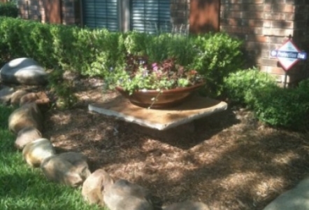 Creek Rock edging and a small slab used to hold a planted pot.