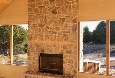 Oklahoma Tumbled Puzzle Rock (brown) on a fireplace for Watermark Design Build Remodel.