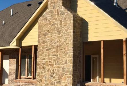 Oklahoma Tumbled Puzzle Rock (brown) on a chimney for Watermark Design Build Remodel.